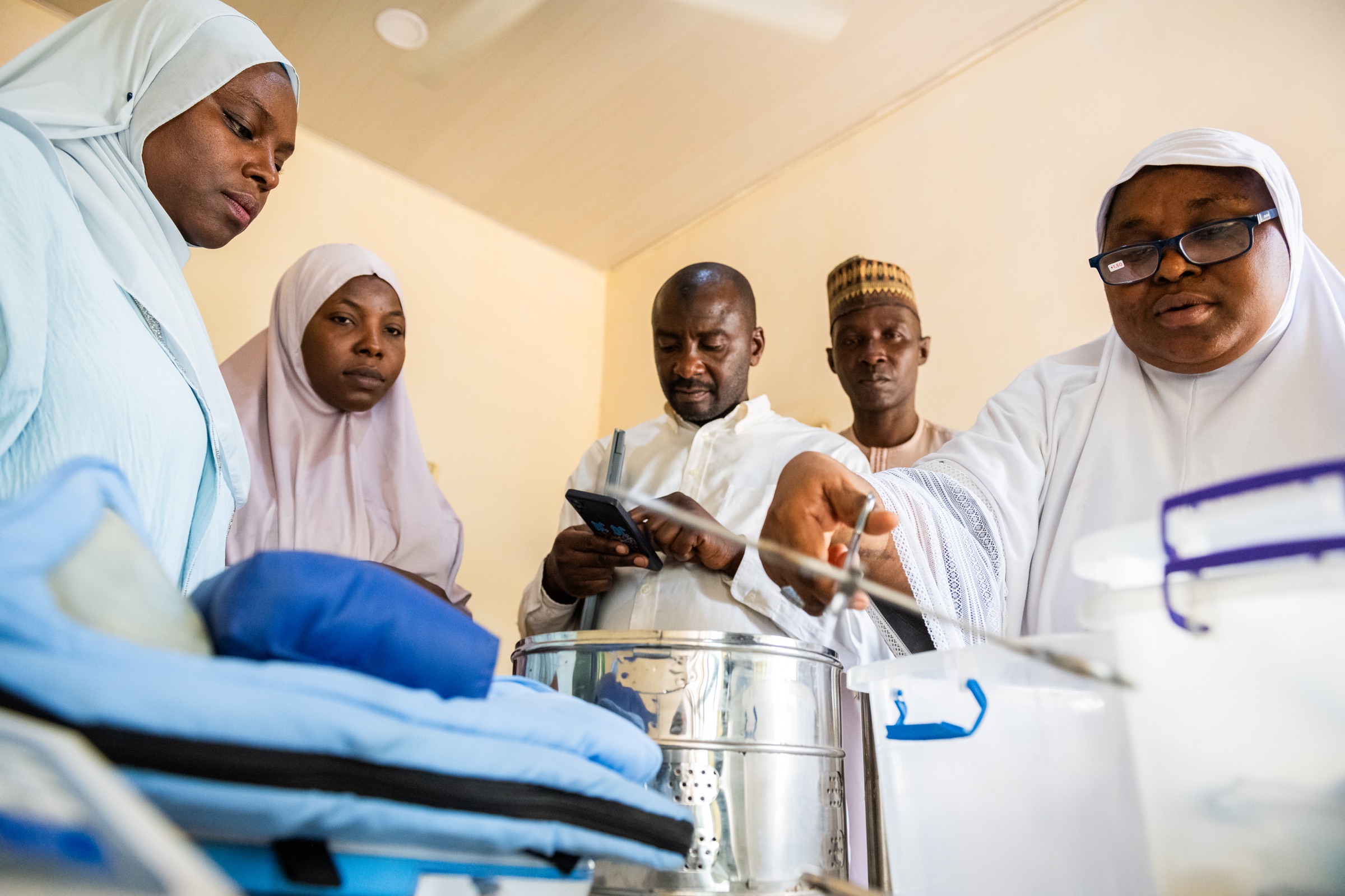 A health care team reviewing clinical equipment together