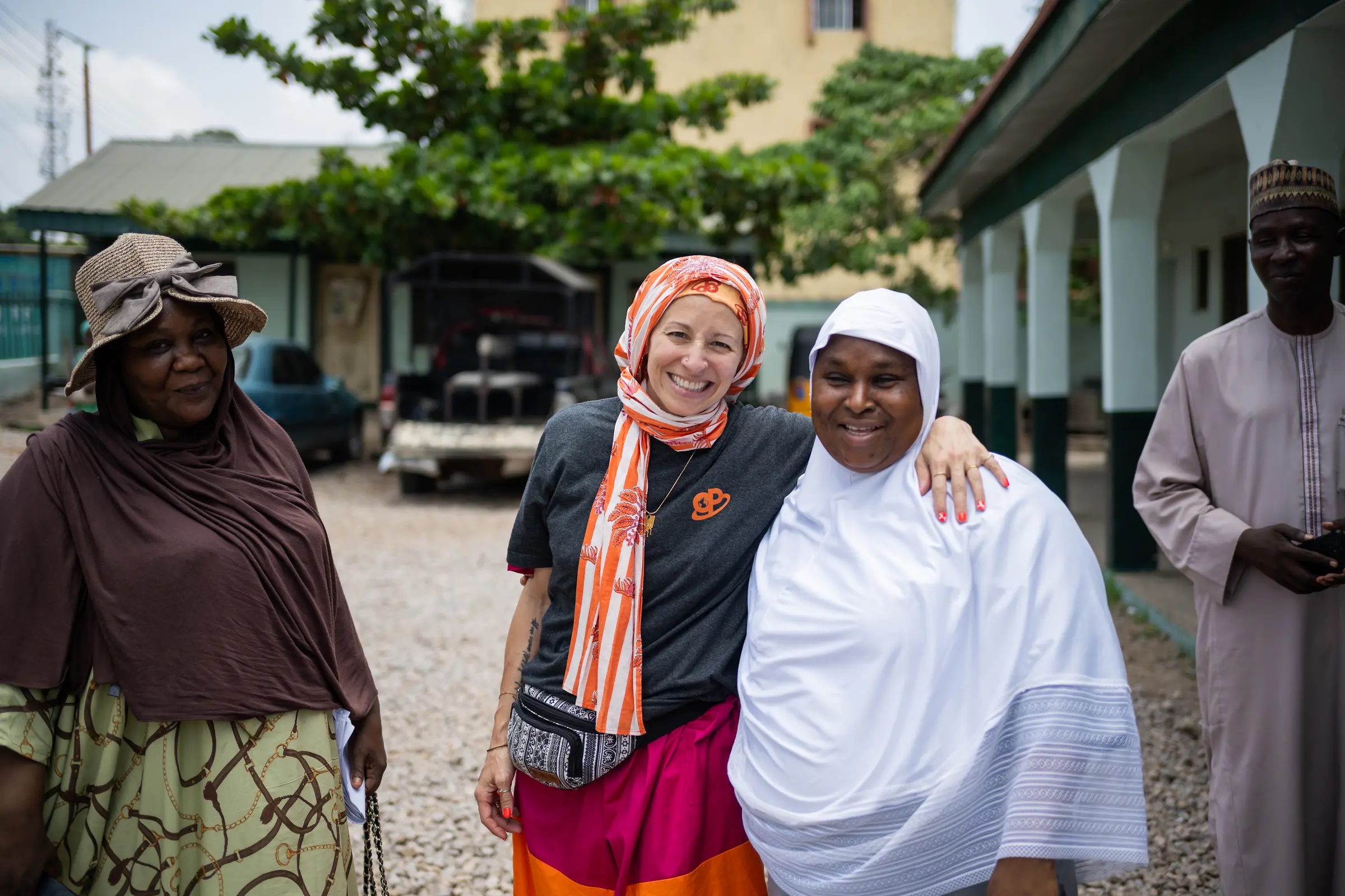 Health partners together outside a Kaduna health facility